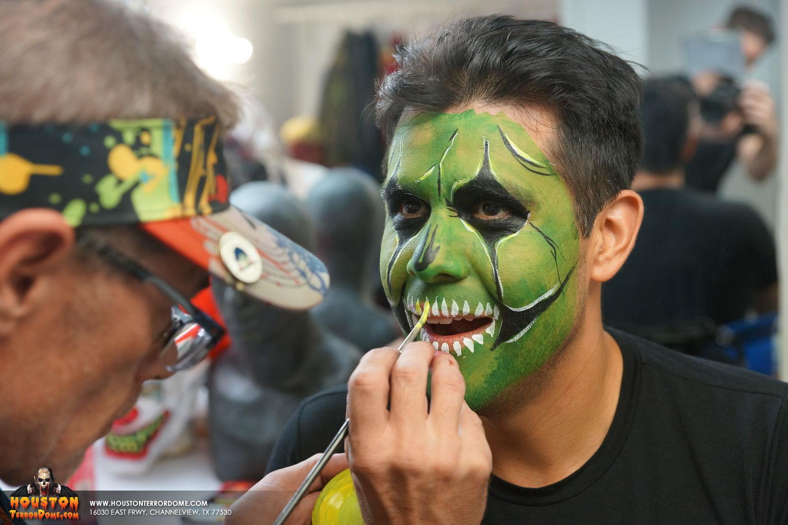 Ruben Galvan of Channel 2 KPRC gets teeth painted on his lips at Houston Terror Dome Haunted House.